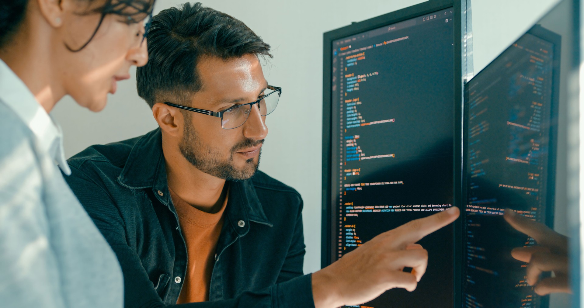 Closeup of Software engineering team engaged in problem-solving and code analysis for web development in modern office. Software developer, artificial intelligence and programming.