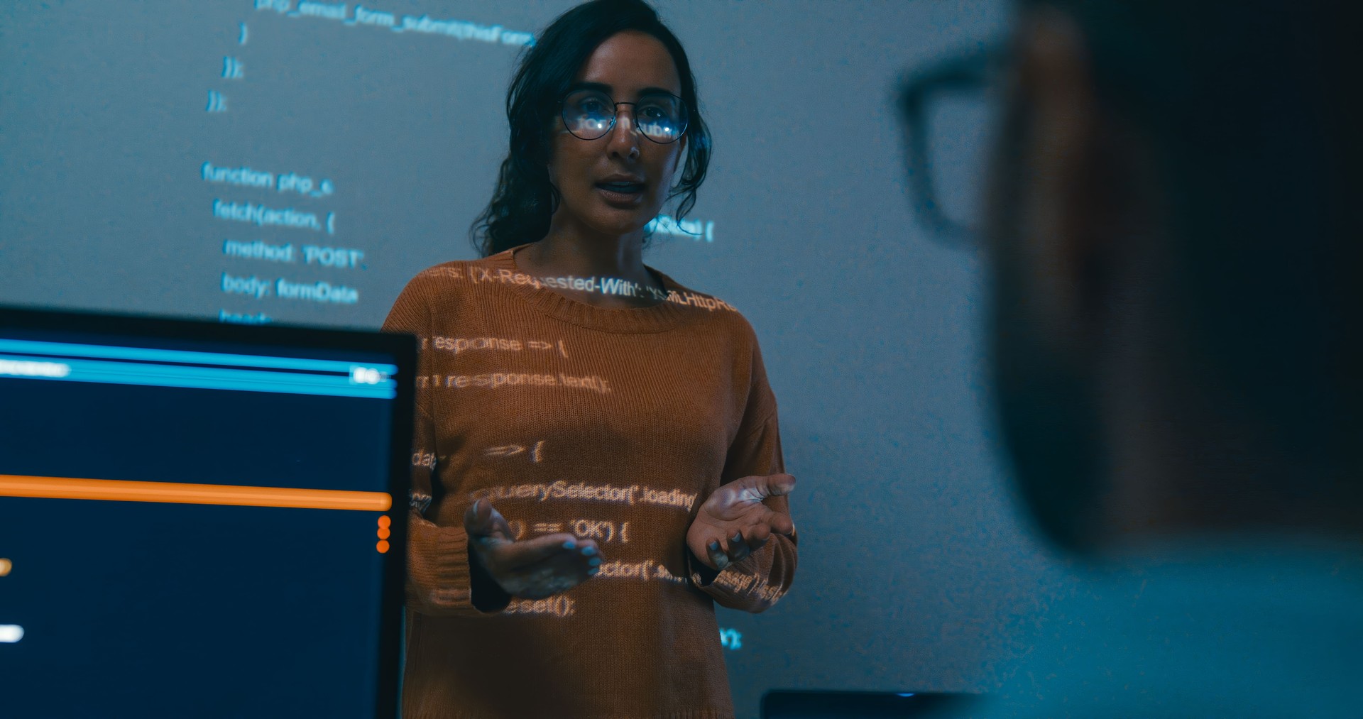 Female programmer is giving an interactive training session, focusing on hands-on learning in digital classroom environment. Software developer, artificial intelligence and programming.